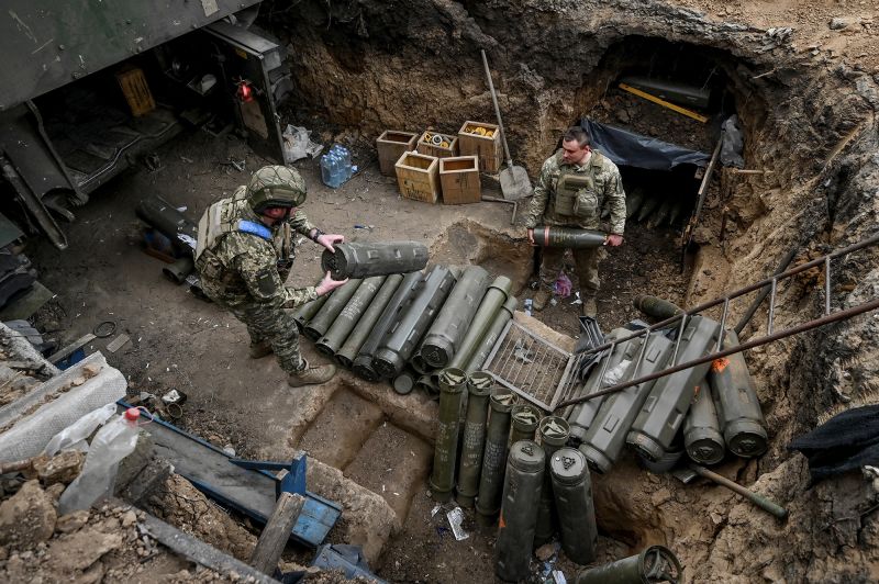 Ukrainian service members prepare shells next to a self-propelled howitzer at a position near a front line in Zaporizhzhia region, Ukraine, on April 3, 2024.