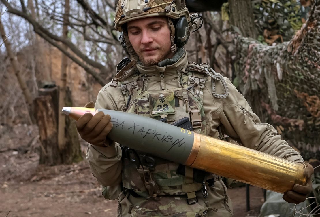 A Ukrainian serviceman prepares a shell inscribed "for Kharkiv" in Donetsk in April.