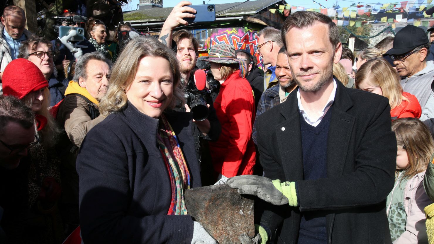 Mayor of Copenhagen Sophie Haestorp Andersen and Danish Justice Minister Peter Hummelgaard hold a cobble stone removed by residents from the area of Freetown Christiania known as the "Pusher Street" on Saturday.