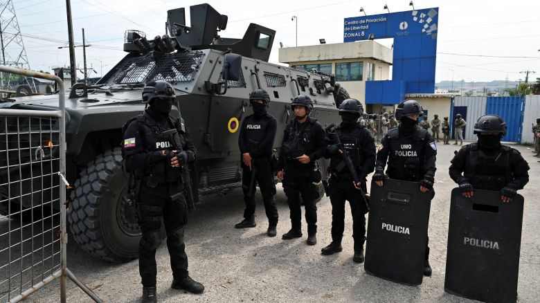 Police officers stand guard as Ecuador's former Vice President Jorge Glas is expected to arrive at the La Roca Prison on Friday.