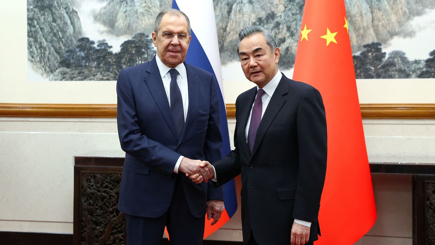 Russia's Foreign Minister Sergey Lavrov shakes hands with China's Foreign Minister Wang Yi during a meeting in Beijing on April 9, 2024.