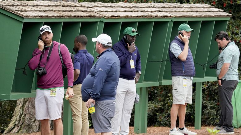 Apr 9, 2024; Augusta, Georgia, USA; Patrons use course phones by the no. 8 tee box during a practice round for the Masters Tournament golf tournament at Augusta National Golf Club. Mandatory Credit: Michael Madrid-USA TODAY Network