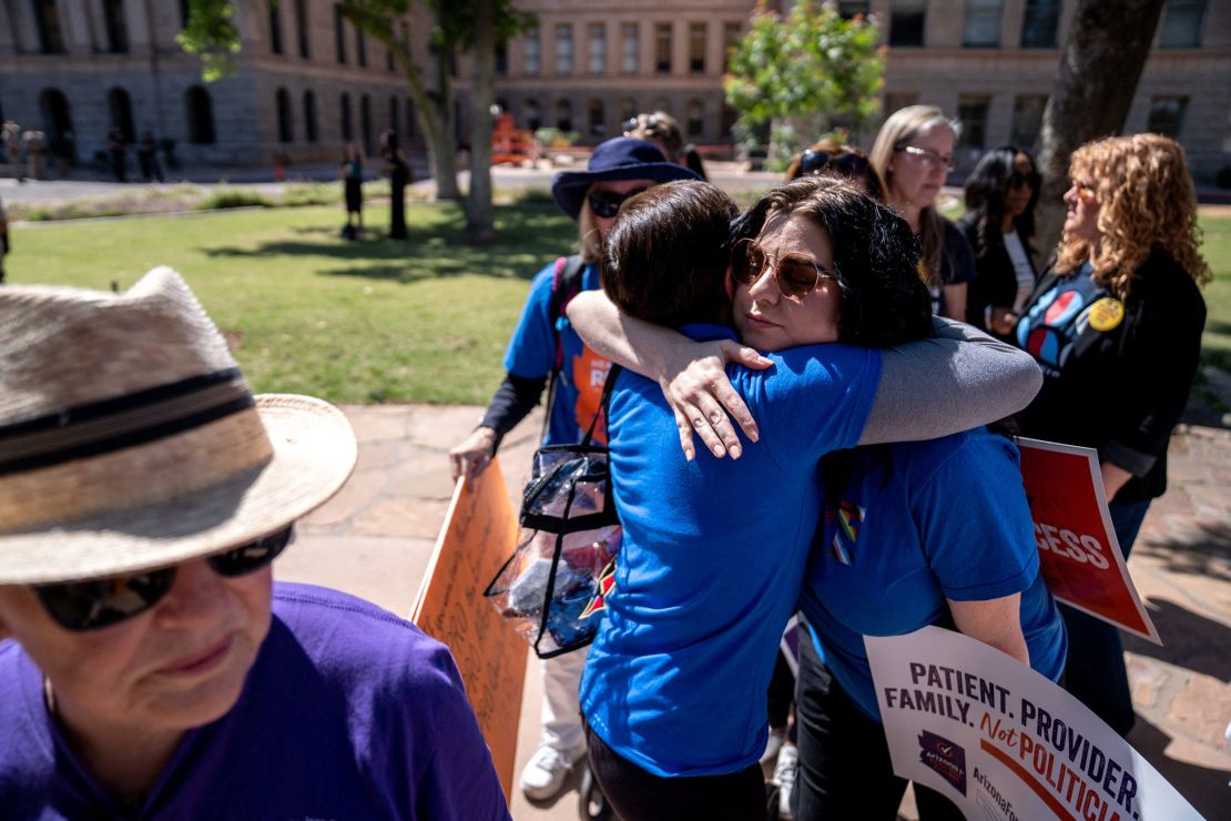 Abortion rights activists Marion Weich and Carolyn LaMantia embrace during a news conference Tuesday addressing the Arizona Supreme Court's ruling at the Arizona state Capitol in Phoenix.