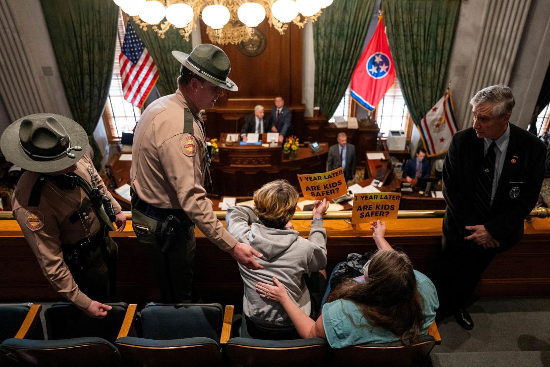 Tennessee State Troopers ask gun reform activists to clear the state Senate gallery.