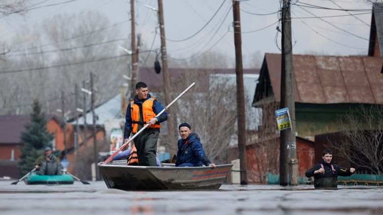 Residents and Russian Emergencies Ministry rescuers ride boats in a flooded street in Orenburg, Russia, April 10, 2024. REUTERS/Maxim Shemetov