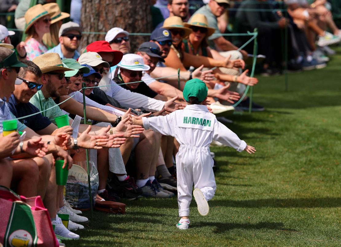 Walter Harman, son of defending Open champion Brian Harman, high fives crowds during the contest.