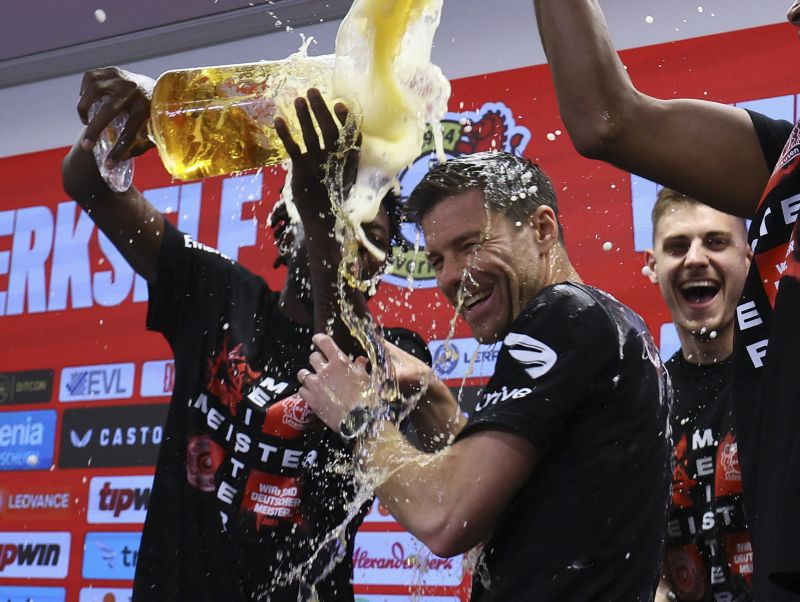 Xabi Alonso drenched in beer by players after Baye
