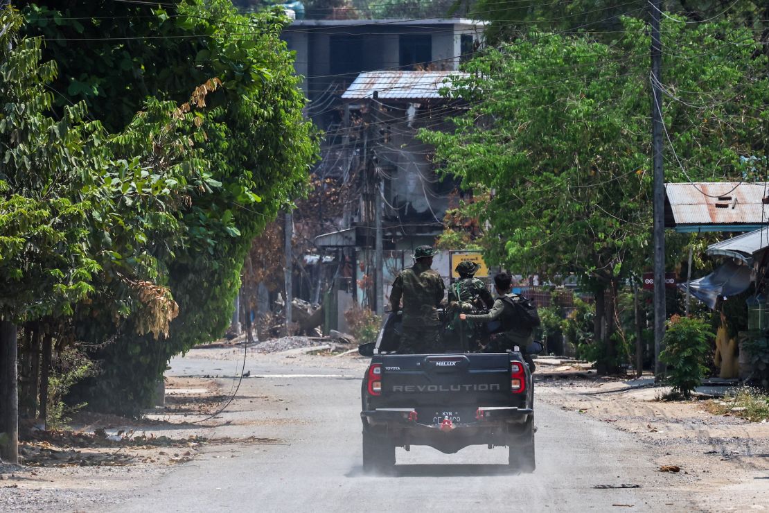 Karen National Liberation Army (KNLA) soldiers patrol a vehicle next to an area destroyed by an airstrike by the Myanmar military in Myawaddy, a Thai-Myanmar border town in Myanmar, April 15, 2024.