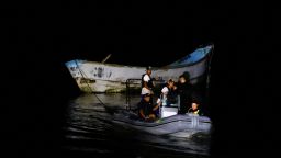 Police officers and rescue workers tow a boat with decomposed bodies found by fishermen, near the Vila do Castelo port in Braganca, Para state, Brazil, on April 14, 2024. REUTERS/Oswaldo Forte