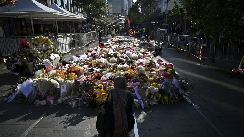 People leave floral tributes for victims of the attack at Westfield Bondi Junction shopping centre in Sydney, Australia April 16, 2024. AAP Image/Steven Saphore via REUTERS ATTENTION EDITORS - THIS IMAGE WAS PROVIDED BY A THIRD PARTY. NO RESALES. NO ARCHIVE. AUSTRALIA OUT. NEW ZEALAND OUT. NO COMMERCIAL OR EDITORIAL SALES IN NEW ZEALAND. NO COMMERCIAL OR EDITORIAL SALES IN AUSTRALIA.