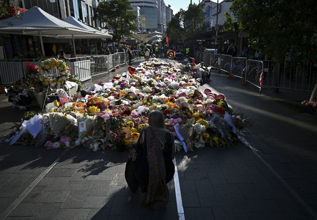 People leave floral tributes for victims of the attack at Westfield Bondi Junction shopping center in Sydney on April 16, 2024.
