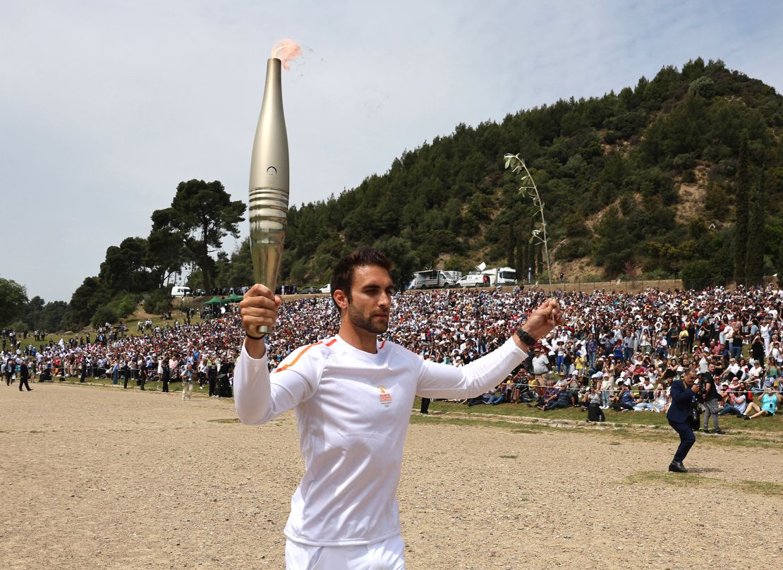 Ntouskos carrying the touch during the start of the relay. Over 600 torchbearers will take part in a 5,000km journey across Greece over the next 11 days before the flame is handed over to France.