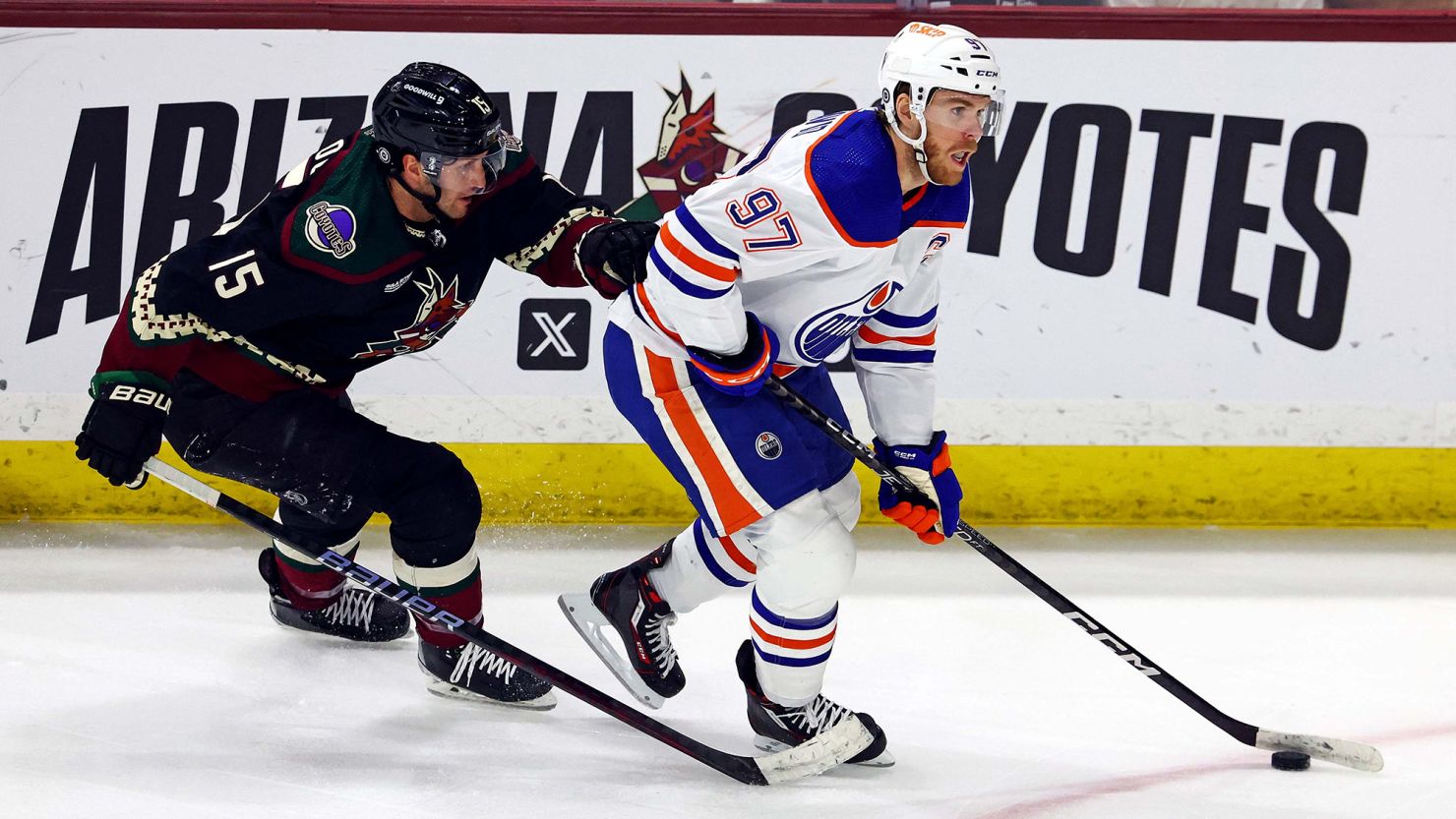 Edmonton Oilers center Connor McDavid (97) moves the puck against Arizona Coyotes center Alex Kerfoot (15) during the second period at Mullett Arena.