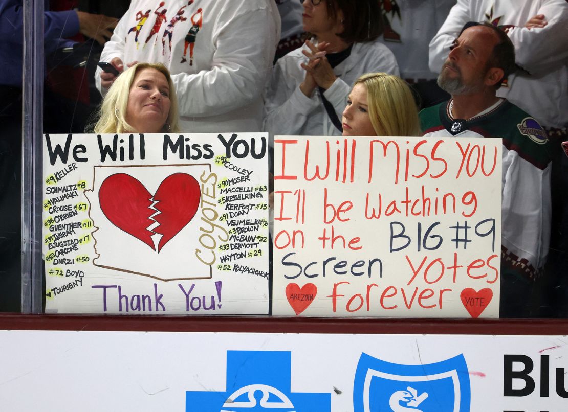 Arizona Coyotes fans in the crowd hold signs for the players following the game against the Edmonton Oilers at Mullett Arena.