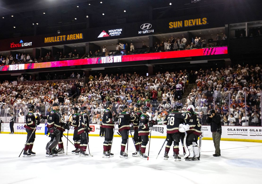 Arizona Coyotes players celebrate together on the ice after defeating the Edmonton Oilers 5-2 at Mullett Arena.