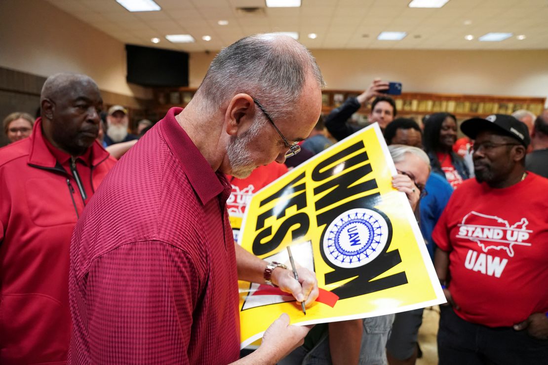 UAW President Shawn Fain signs a placard after the result of a vote comes in favor of the hourly factory workers at Volkswagen's assembly plant in Chattanooga, Tennessee joining the union, on April 19.