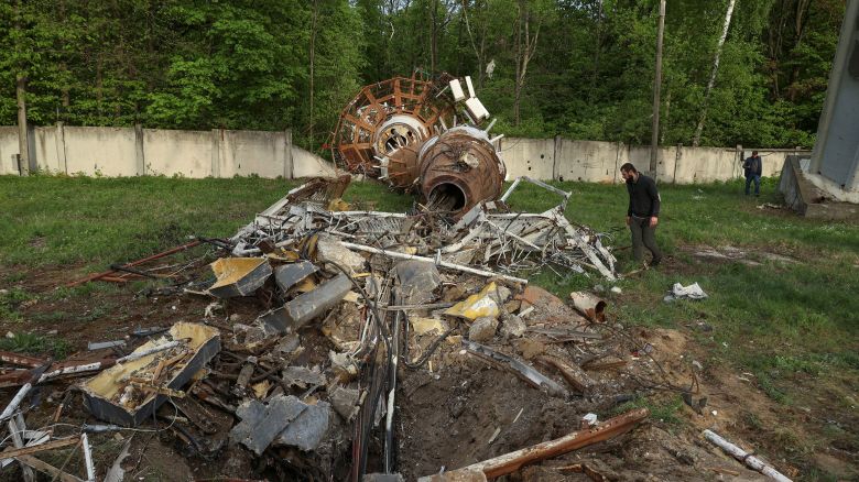 People walk next to a part of a television tower partially destroyed by a Russian missile strike, amid Russia's attack on Ukraine, in Kharkiv, Ukraine April 22, 2024. REUTERS/Sofiia Gatilova