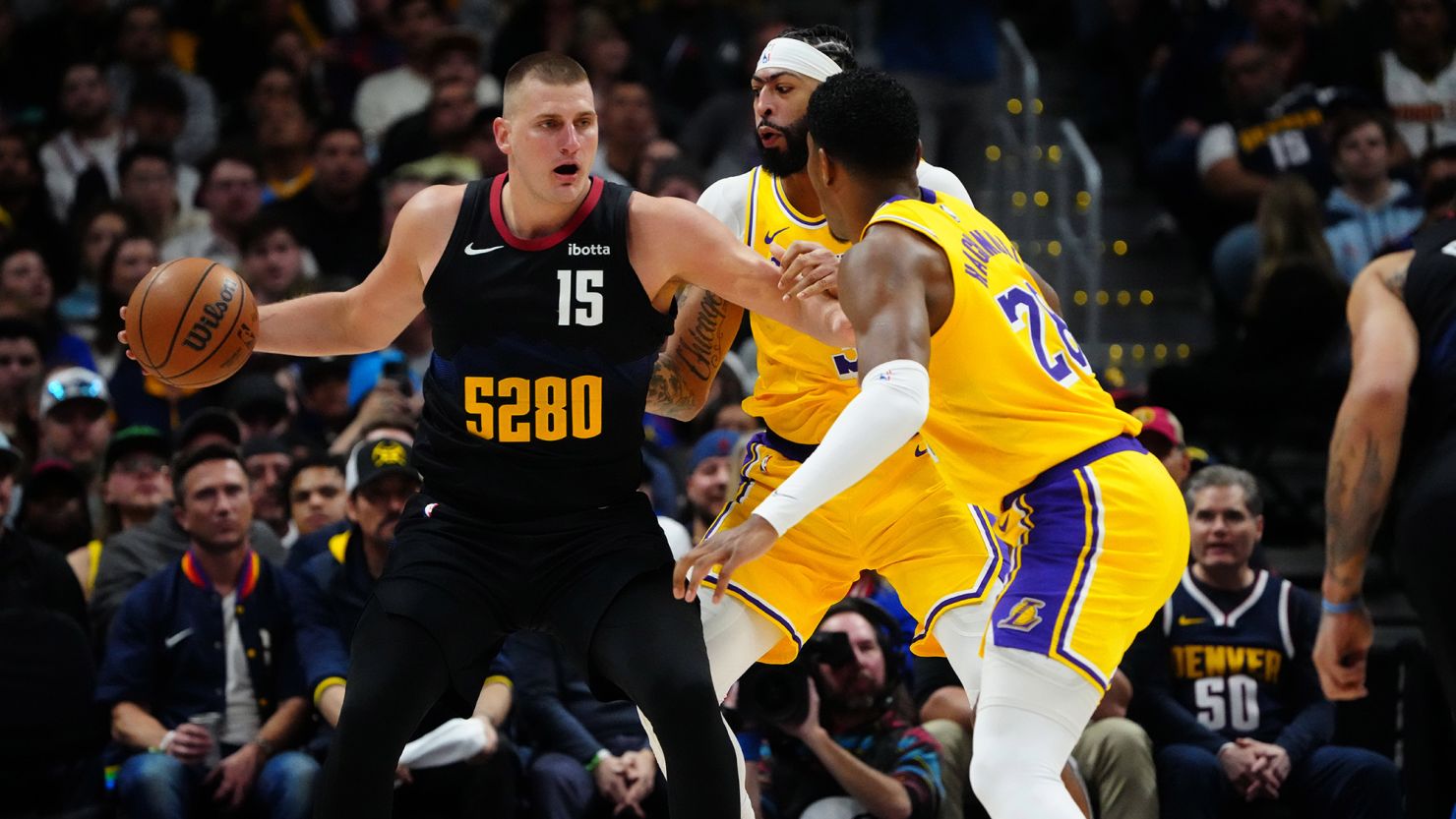 Nikola Jokić is defended by Los Angeles Lakers defenders Anthony Davis and Rui Hachimura during Game 2 of the Denver Nuggets' first round playoff series against the Lakers in the 2024 NBA Playoffs.