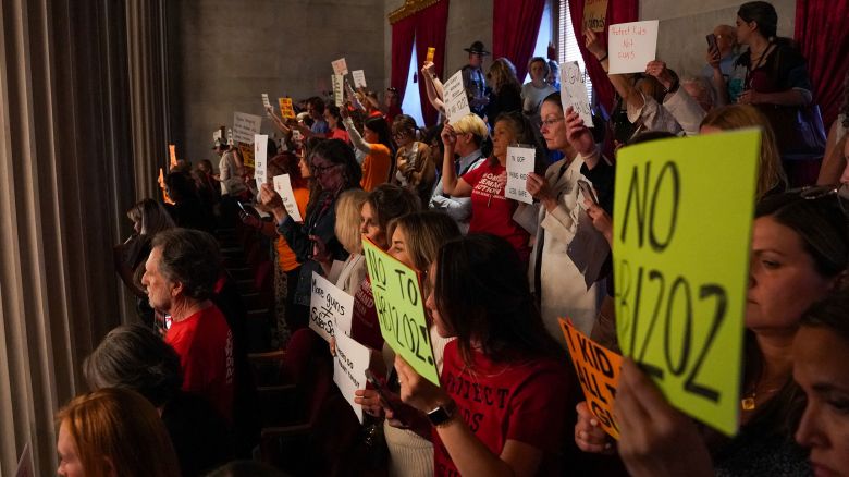 Gun reform activists protest in the House gallery at the Tennessee State Capitol building, as the House votes to adopt Senate Bill SB1325 which would authorize teachers, principals, and school personnel to carry a concealed handgun on school grounds, in Nashville, Tennessee, U.S., April 23, 2024.   REUTERS/Seth Herald