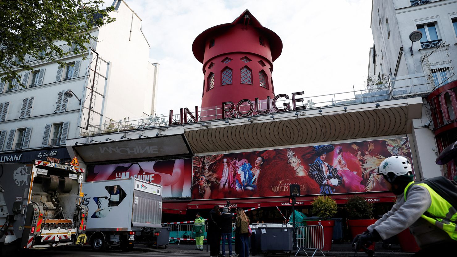 The Moulin Rouge in Paris with its name partially snapped off after the blades of its prominent red windmill fell off overnight.