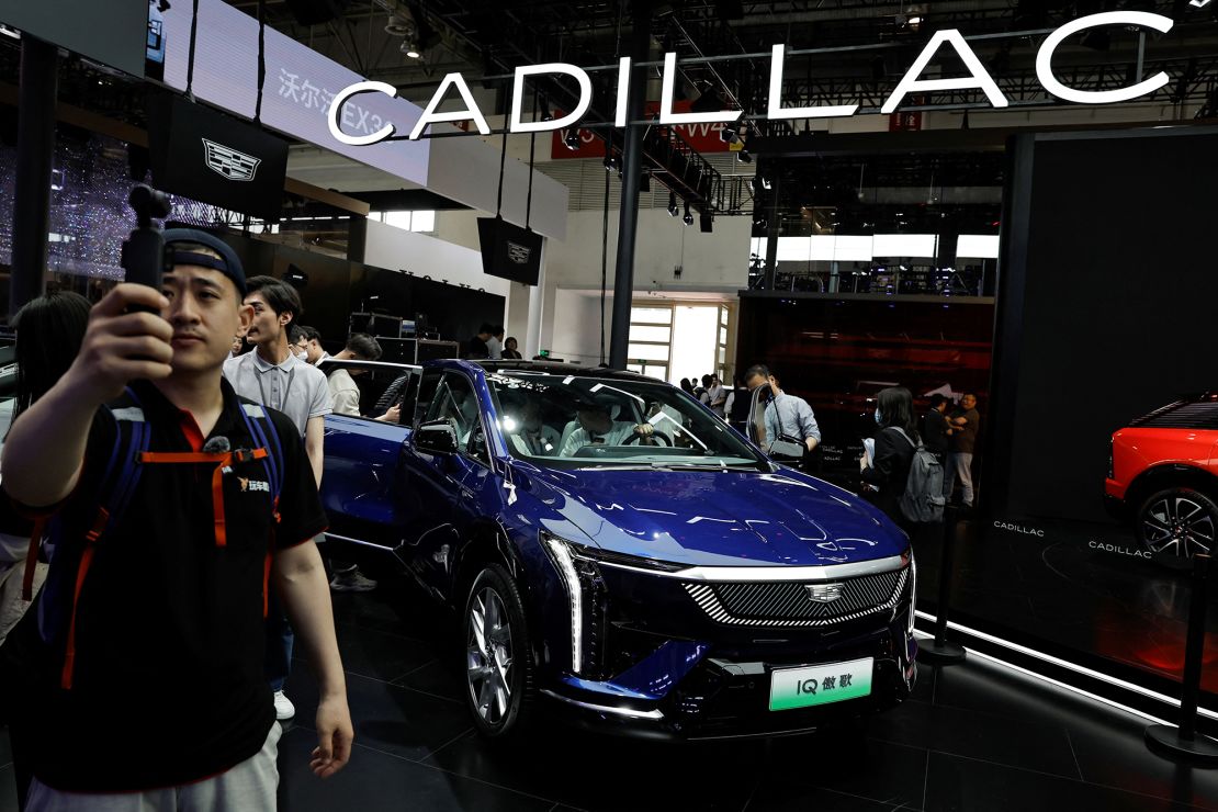 Visitors look at the Cadillac Escalade IQ electric SUV at the Beijing International Automotive Exhibition in Beijing, China, on April 25.