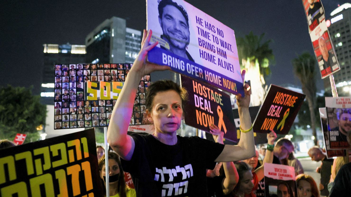 Protesters hold posters calling for the immediate release of Israeli hostages held in Gaza, in Tel Aviv, Israel, on Thursday.