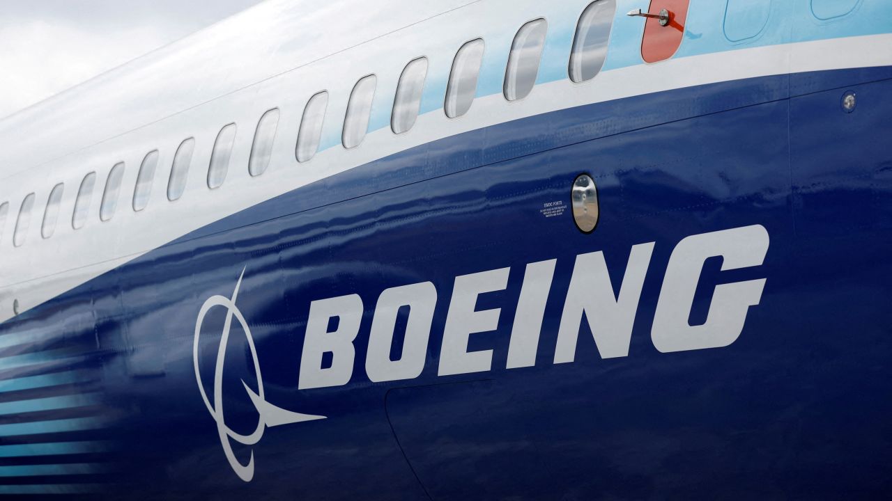 FILE PHOTO: The Boeing logo is seen on the side of a Boeing 737 MAX at the Farnborough International Airshow, in Farnborough, Britain, July 20, 2022.  REUTERS/Peter Cziborra/File Photo