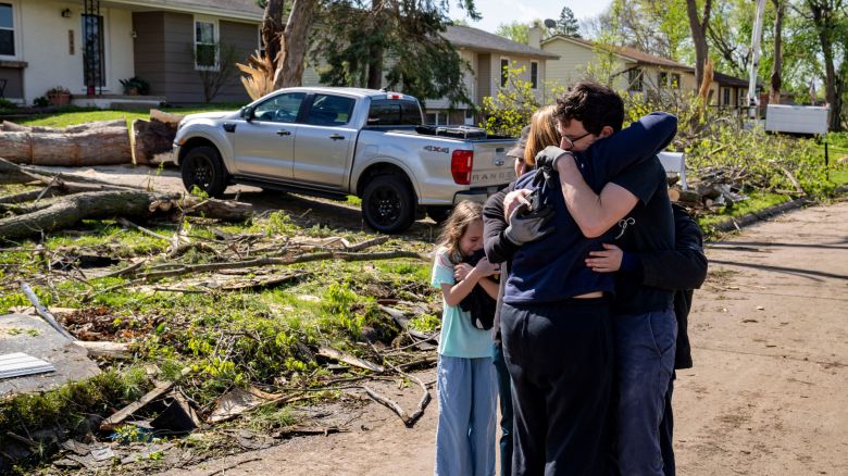 Neighbors embrace Penny Thomsen outside of her home after multiple tornadoes ripped across the state the evening before, in the Des Moines suburb of Pleasant Hill, Iowa, U.S., April 27, 2024.  Zach Boyden-Holmes/The Register/USA Today Network via REUTERS    NO RESALES. NO ARCHIVES. MANDATORY CREDIT