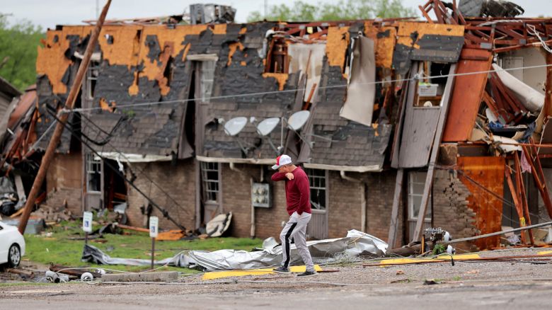 A man walks past a damaged building after it was hit by a tornado the night before in Sulphur, Oklahoma, U.S. April 28, 2024.
