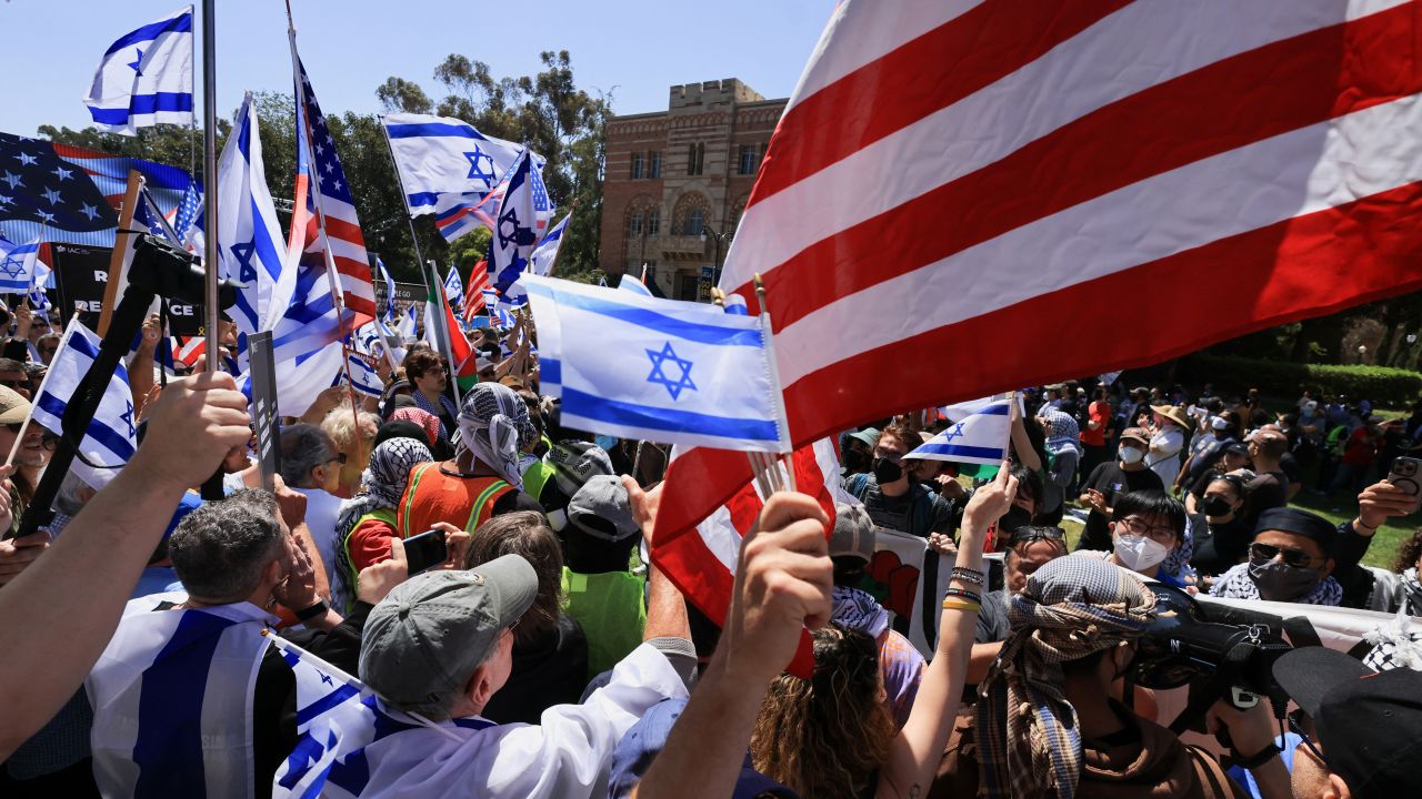 People hold Israeli and U.S. flags as pro-Israel counter-protesters gather during a demonstration in support of Palestinians in Gaza amid the ongoing conflict between Israel and the Palestinian Islamist group Hamas, at the University of California Los Angeles (UCLA) in Los Angeles, California, U.S. April 28, 2024.