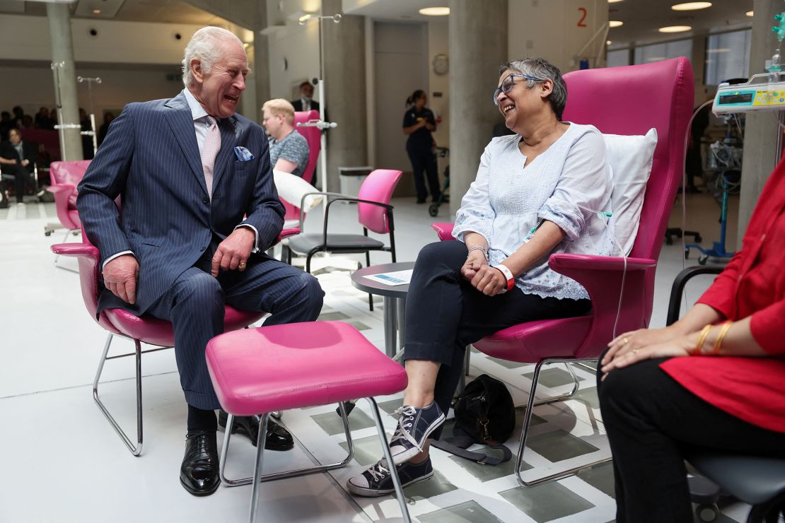 Charles seemed relaxed and at ease as he chatted with several patients at the center including Asha Millan, pictured. 