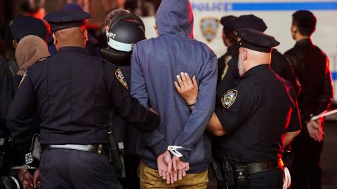 Police detain a protester as other police officers enter the campus of Columbia University in New York City on April 30, 2024.