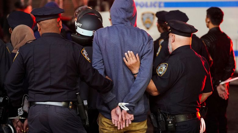 Police detain a protester as other police officers enter the campus of Columbia University in New York City on April 30, 2024.