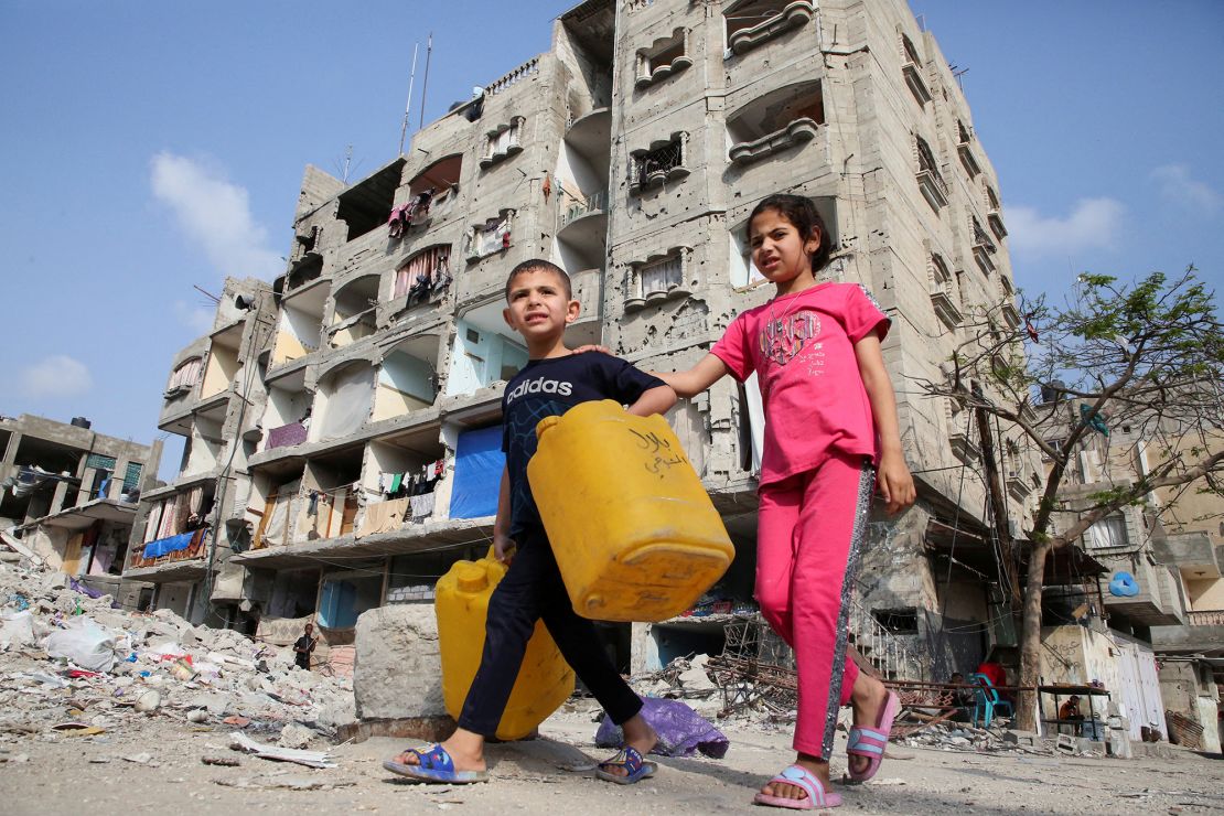 Palestinian children walk past a house damaged in an Israeli strike in Rafah, in the southern Gaza Strip, on May 1, 2024.