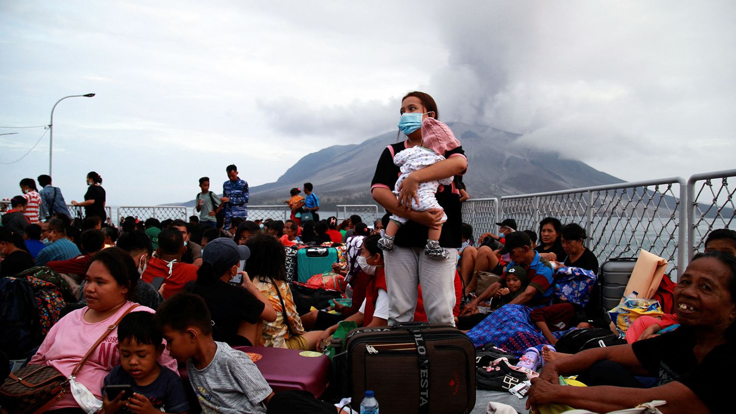 Families evacuate following eruptions of Mount Ruang volcano in North Sulawesi province, Indonesia, on May 1, 2024.