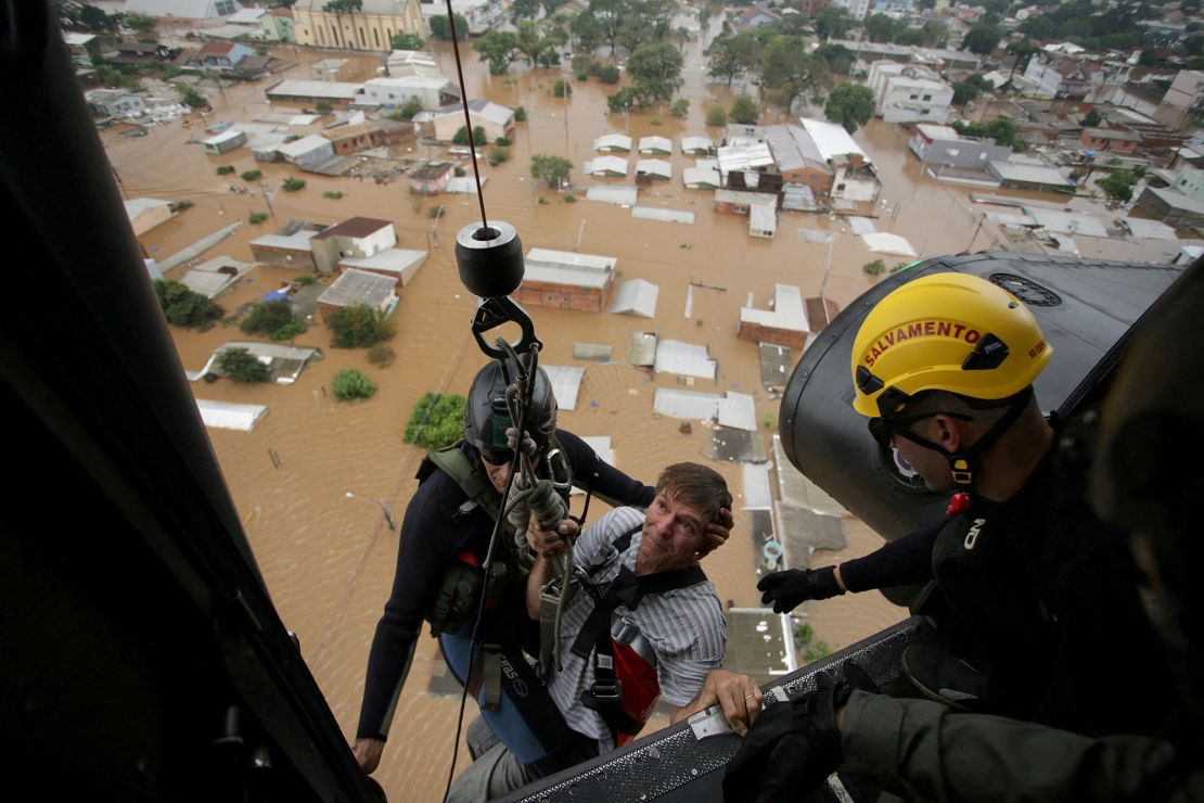 A man is rescued by military firefighters after the floods in Canoas on May 4, 2024.