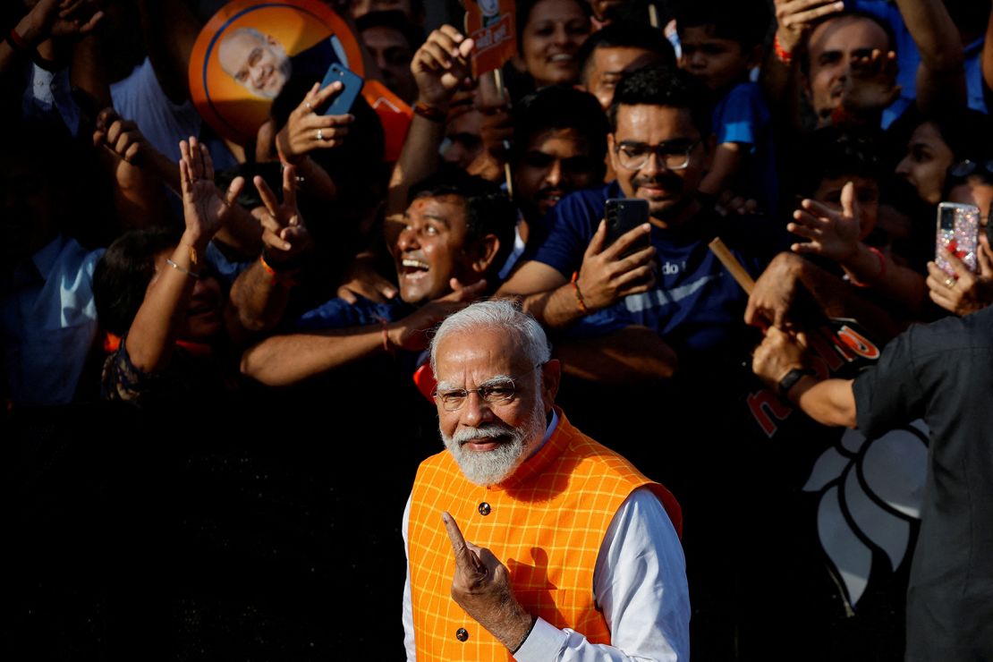 India's Prime Minister Narendra Modi shows his ink-marked finger after casting his vote outside a polling station in Ahmedabad, India, on May 7, 2024.
