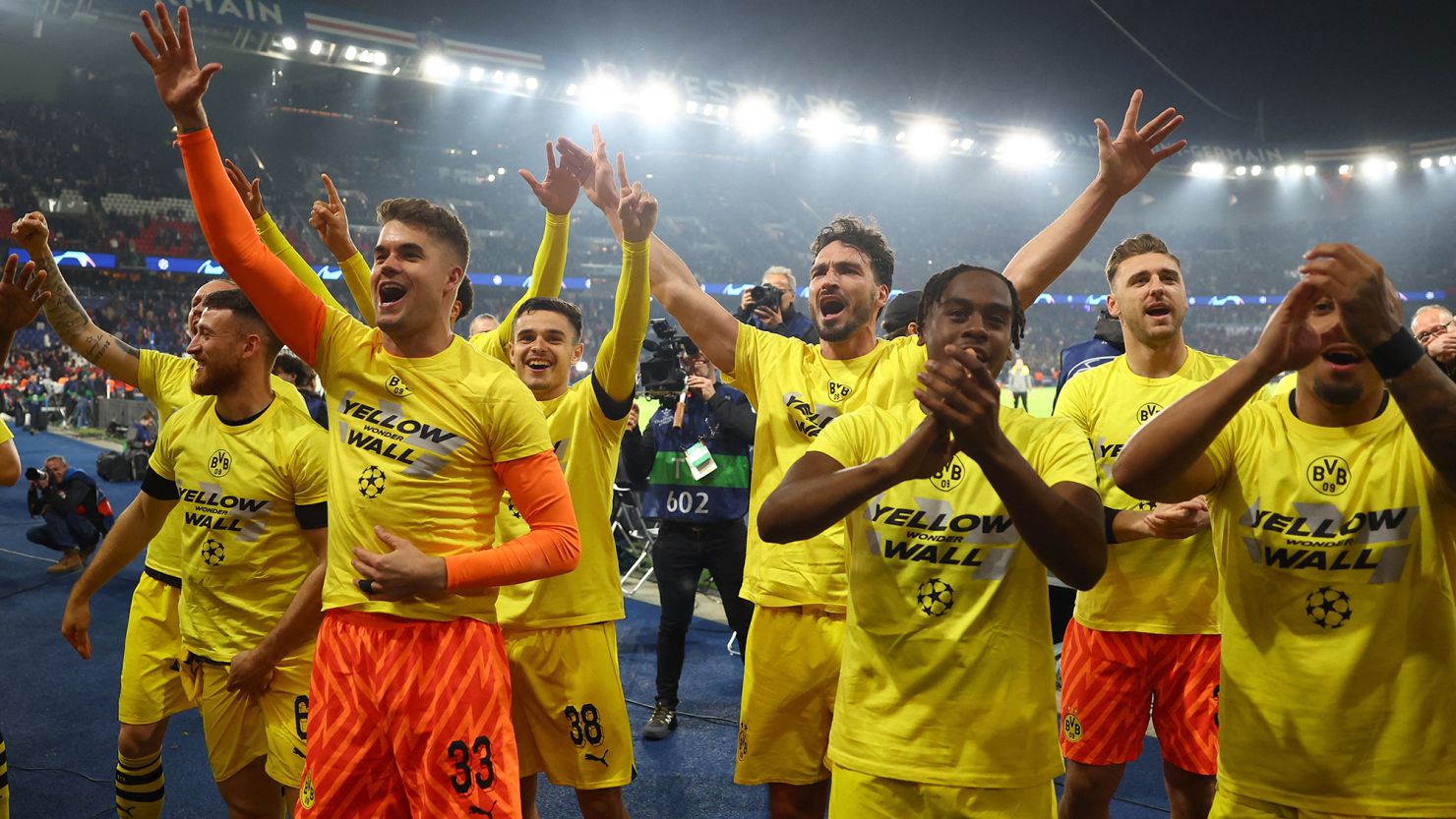 Borussia Dortmund players celebrate with fans after reaching the Champions League final.