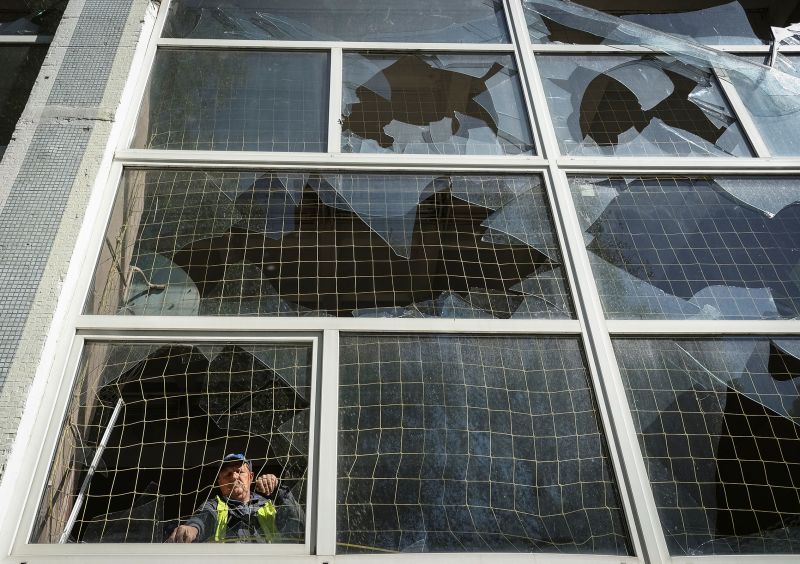 A worker removes shards of glass from a broken window, at a school damaged by a Russian missile strike in Kharkiv, Ukraine on May 8, 2024.