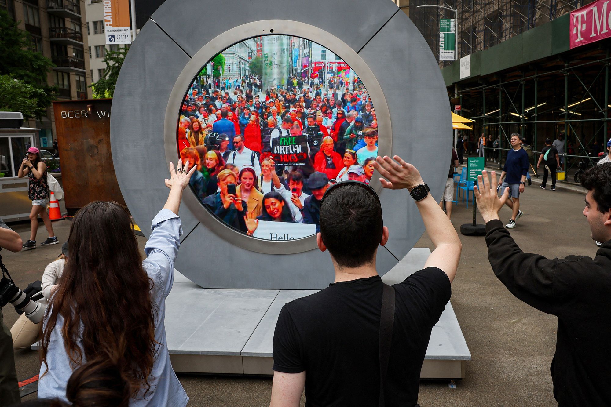 People in New York City wave to Dubliners on the other side of the installation.