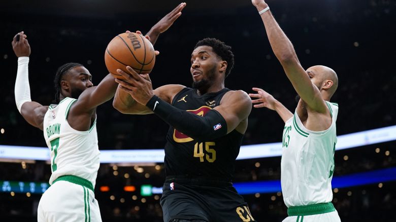 May 9, 2024; Boston, Massachusetts, USA; Cleveland Cavaliers guard Donovan Mitchell (45) passes the ball against Boston Celtics guard Jaylen Brown (7) and guard Derrick White (9) in the first quarter during game two of the second round for the 2024 NBA playoffs at TD Garden. Mandatory Credit: David Butler II-USA TODAY Sports