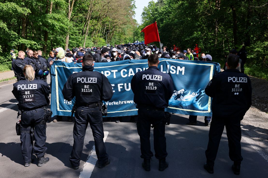 A police officer stands in front of activists protesting the expansion of the Tesla factory near Berlin, Germany, on May 10, 2024.