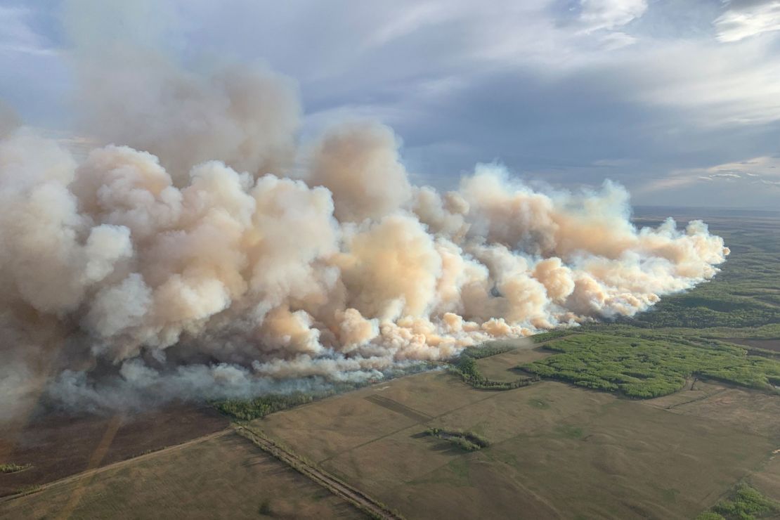 Smoke rises Friday from mutual aid wildfire GCU007 in the Grande Prairie Forest Area near TeePee Creek, Alberta.