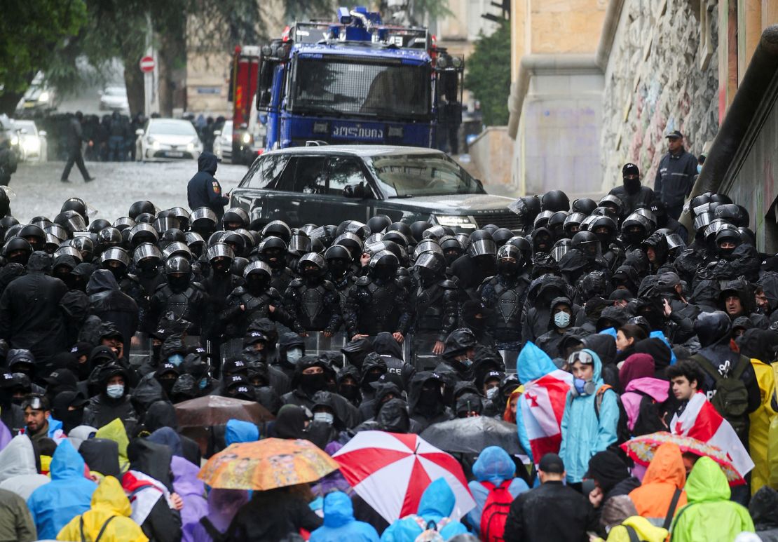 Protesters stare down riot police outside the Georgian Parliament.