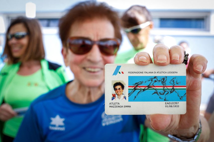Mazzenga shows her membership card for the Italian Athletics Federation, ahead of the women's 100m W90 category race on May 4, 2024.
