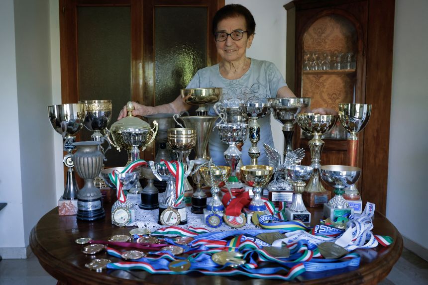Italian master runner Emma Maria Mazzenga poses for a picture with some of her trophies, at home on May 5, 2024.