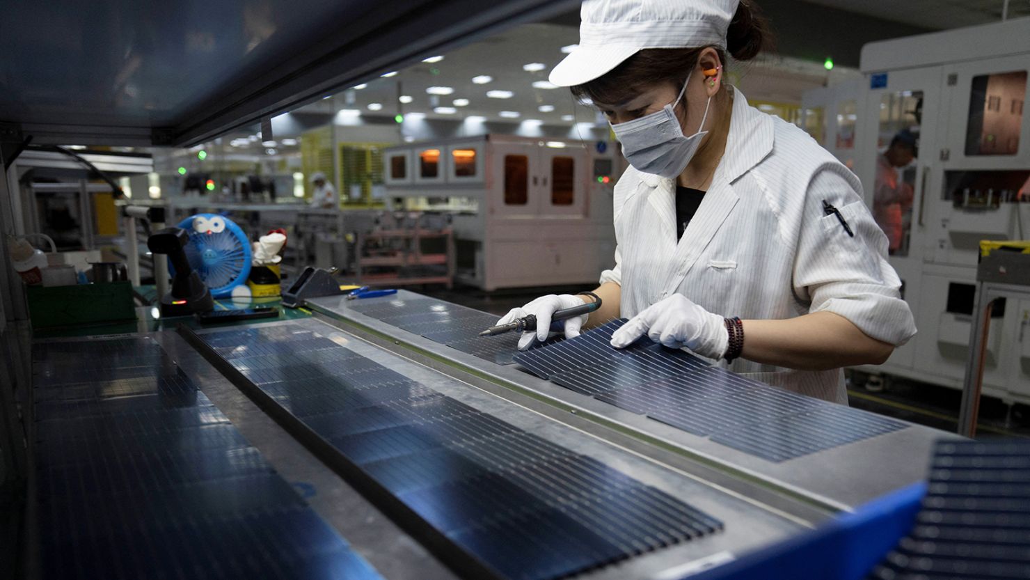 An employee works on the production line for solar panels at a GCL System Integration Technology factory in Hefei, Anhui province, China on May 16, 2024.