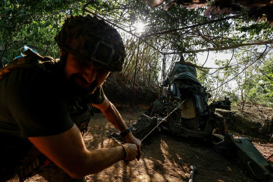 A Ukrainian serviceman fires a howitzer toward Russian troops in Donetsk region.