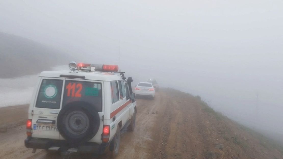 In this still from a video, an ambulance and other vehicles drive on a foggy road following a crash of a helicopter carrying Iran's President Ebrahim Raisi, in Varzaqan, East Azerbaijan Province, Iran, on May 19.