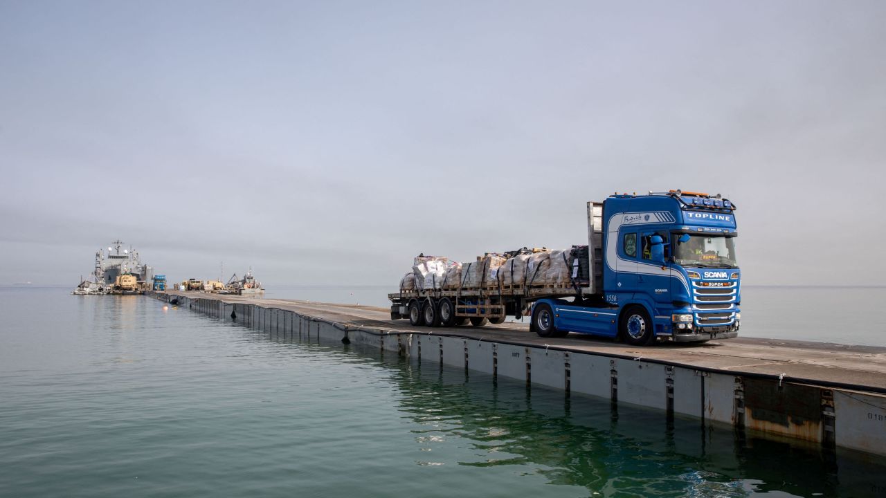 A truck carries humanitarian aid across Trident Pier, a temporary pier to deliver aid, off the Gaza Strip, amid the ongoing conflict between Israel and the Palestinian Islamist group Hamas, near the Gaza coast, on May 19, 2024.